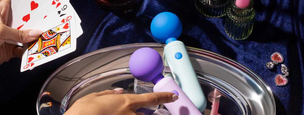 two dex compact vibrators on a tray with a hand pointing
