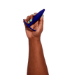 Hand holding navy blue silicone butt plug called nudge
